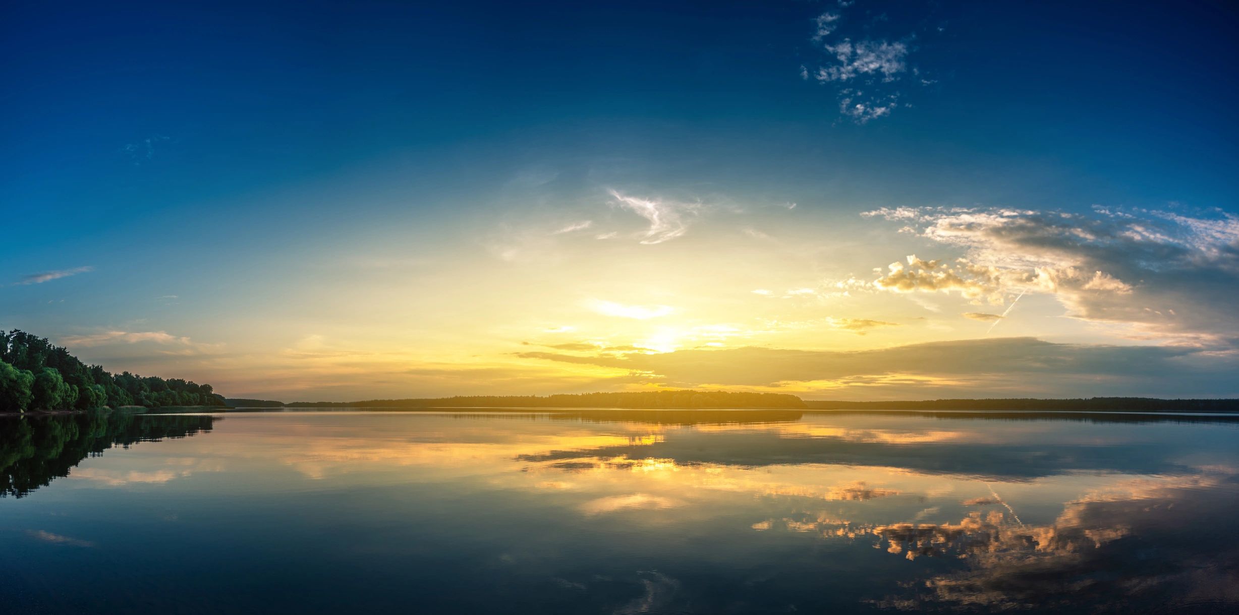 Sunrise over a calm lake, representing hope and steadiness