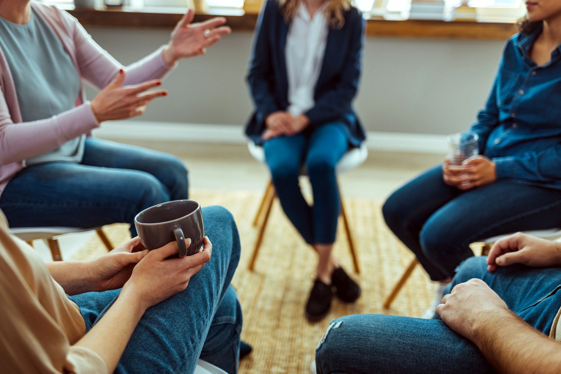 Hands gesturing during a group therapy conversation